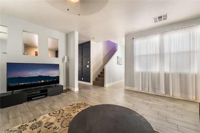 632 Monument Point St, Henderson, NV 89002 - living area with wood finished floors, baseboards, a ceiling fan, and stairway