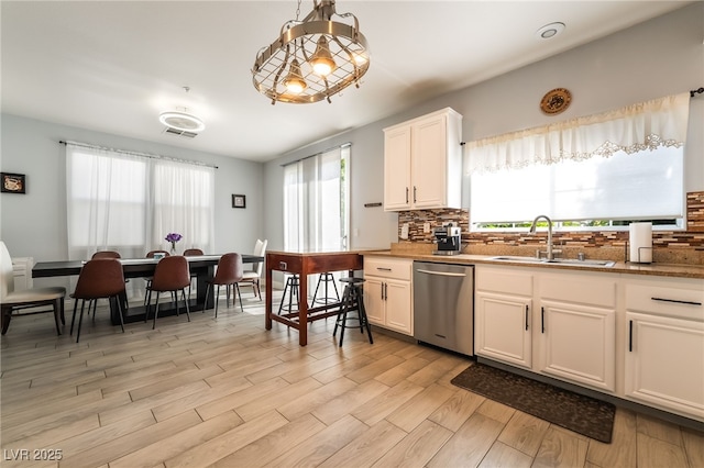 632 Monument Point St, Henderson, NV 89002 - kitchen featuring dishwasher, a sink, decorative backsplash, light wood-type flooring, and white cabinetry