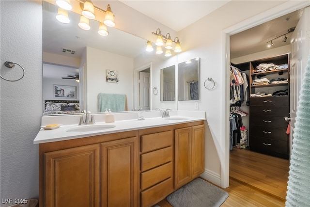 632 Monument Point St, Henderson, NV 89002 - bathroom featuring double vanity, wood finished floors, and a spacious closet