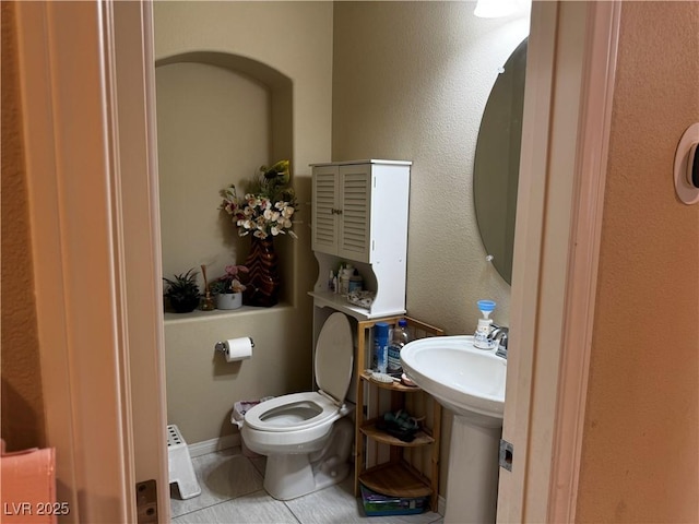 6454 Mount Palomar Ave, Las Vegas, NV 89139 - half bathroom with tile patterned floors, toilet, and a sink
