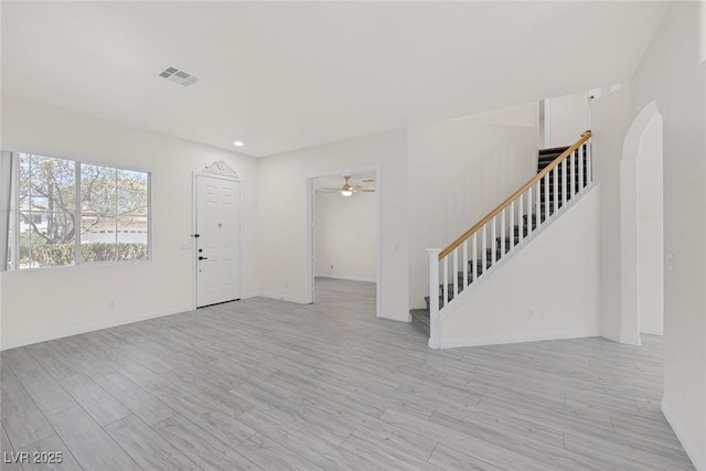 2367 Tilden Way, Henderson, NV 89074 - foyer with stairs, ceiling fan, arched walkways, light wood finished floors, and baseboards