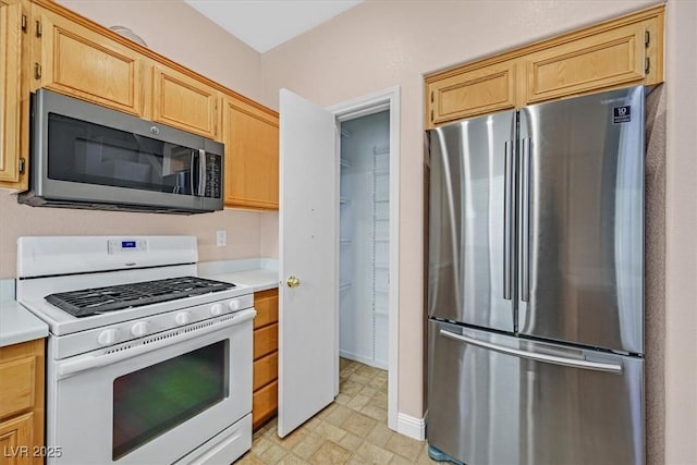 927 Clear Diamond Ave, Las Vegas, NV 89123 - kitchen featuring freestanding refrigerator, white gas range, light countertops, and light floors