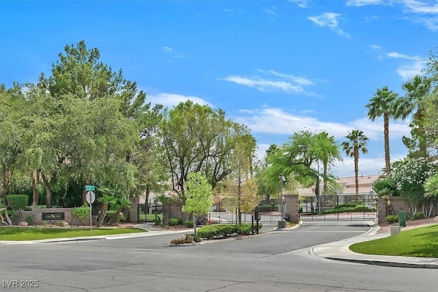 927 Clear Diamond Ave, Las Vegas, NV 89123 - view of asphalt road with a gate, a gated entry, traffic signs, and curbs