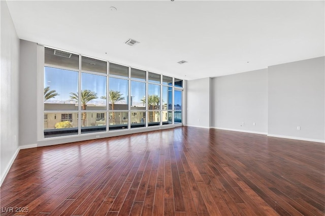4575 Dean Martin Dr Unit 304, Las Vegas, NV 89103 - spare room featuring wood finished floors, a wall of windows, healthy amount of natural light, and baseboards