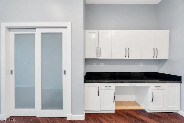 4575 Dean Martin Dr Unit 304, Las Vegas, NV 89103 - kitchen with white cabinetry and dark wood finished floors