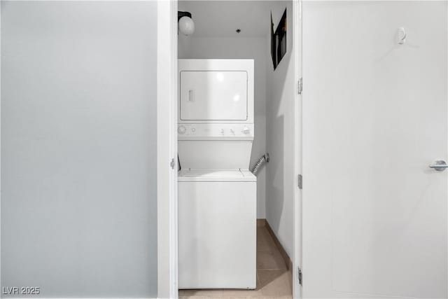 4575 Dean Martin Dr Unit 304, Las Vegas, NV 89103 - laundry room with estacked washer and dryer and light tile patterned flooring