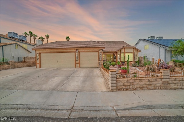 6508 Peppermill Dr, Las Vegas, NV 89146 - view of front facade with concrete driveway, a garage, stucco siding, and a tiled roof