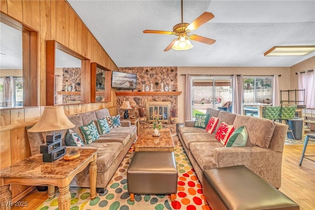 6508 Peppermill Dr, Las Vegas, NV 89146 - living area featuring a textured ceiling, lofted ceiling, wood finished floors, ceiling fan, and wood walls