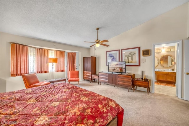 6508 Peppermill Dr, Las Vegas, NV 89146 - bedroom with carpet floors, a textured ceiling, vaulted ceiling, and connected bathroom