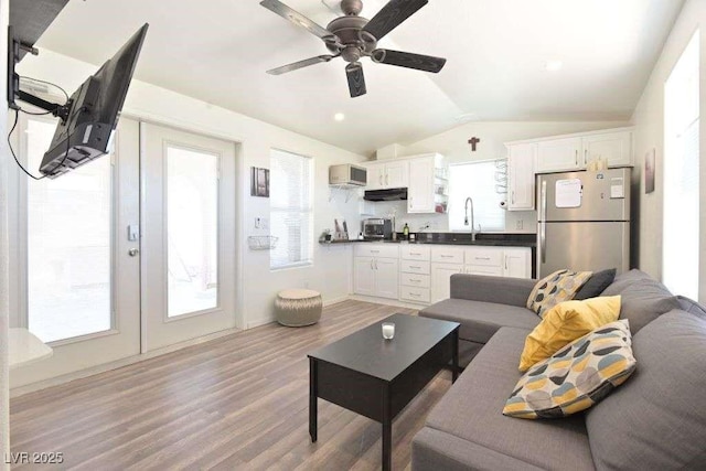 275 Vegas Dr, Goodsprings, NV 89019 - living room featuring vaulted ceiling, ceiling fan, light wood-style floors, and baseboards