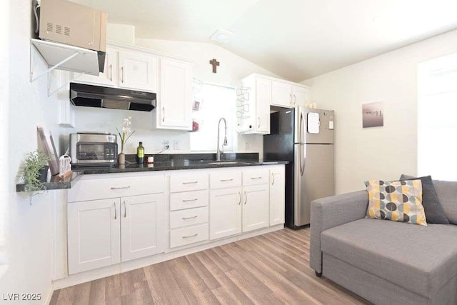 275 Vegas Dr, Goodsprings, NV 89019 - kitchen featuring freestanding refrigerator, a sink, under cabinet range hood, lofted ceiling, and light wood-type flooring