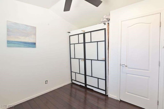 275 Vegas Dr, Goodsprings, NV 89019 - unfurnished bedroom with dark wood-style flooring, baseboards, lofted ceiling, and a ceiling fan