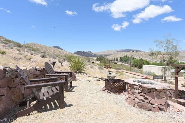 275 Vegas Dr, Goodsprings, NV 89019 - view of patio / terrace with a mountain view and an outdoor fire pit