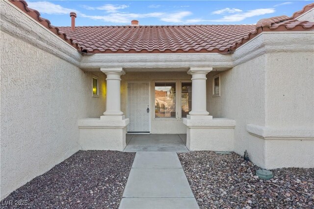 9105 Marble Dr, Las Vegas, NV 89134 - property entrance with stucco siding, a tile roof, and a porch