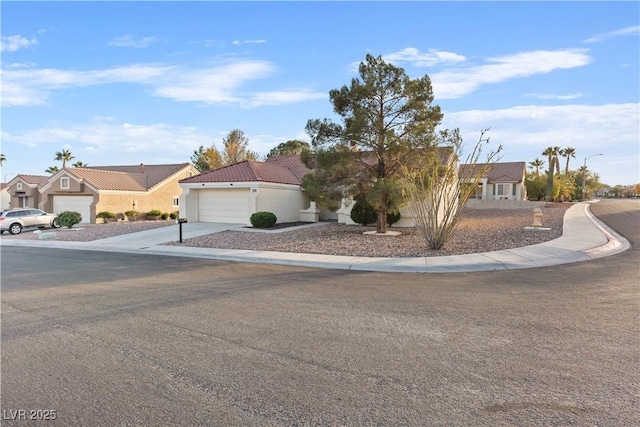 9105 Marble Dr, Las Vegas, NV 89134 - view of front facade with a garage, concrete driveway, a residential view, a tiled roof, and stucco siding