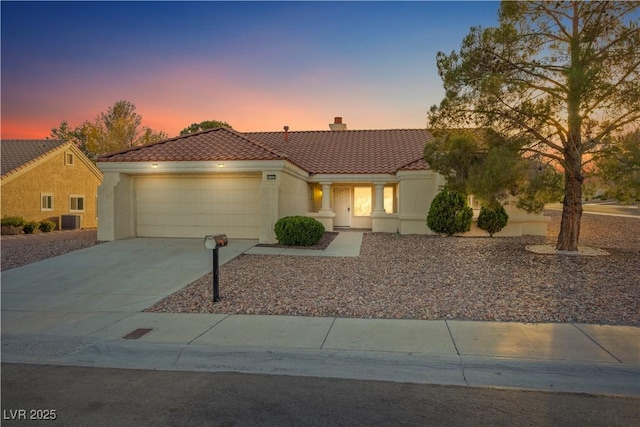 9105 Marble Dr, Las Vegas, NV 89134 - view of front of home featuring a tile roof, a chimney, a garage, driveway, and stucco siding