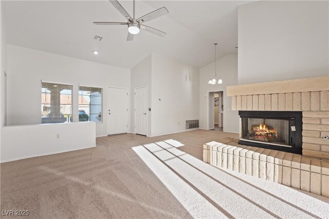 9105 Marble Dr, Las Vegas, NV 89134 - unfurnished living room featuring high vaulted ceiling, baseboards, a chandelier, light carpet, and a fireplace