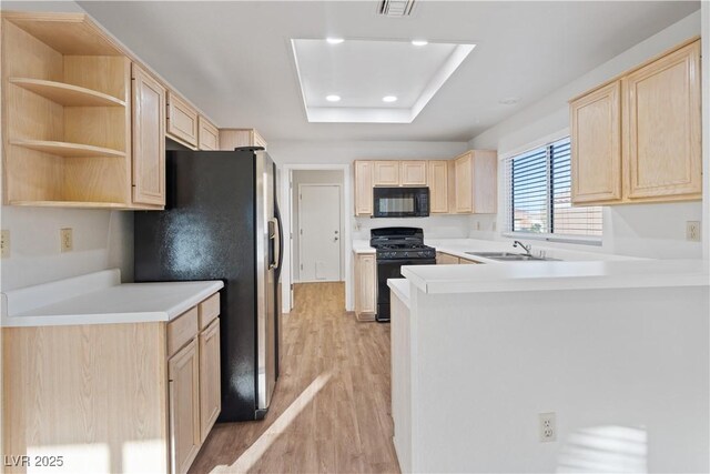 9105 Marble Dr, Las Vegas, NV 89134 - kitchen featuring black appliances, light brown cabinetry, light wood-style flooring, and recessed lighting