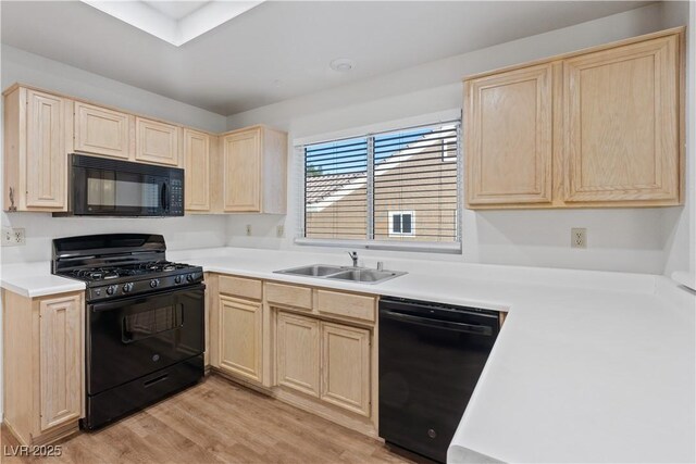 9105 Marble Dr, Las Vegas, NV 89134 - kitchen with light brown cabinets, black appliances, a sink, and light wood-type flooring