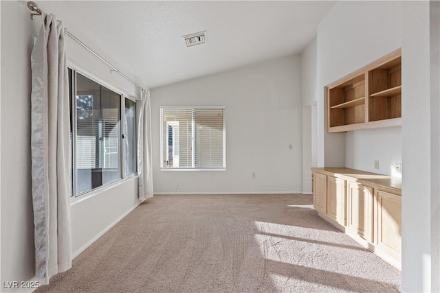 9105 Marble Dr, Las Vegas, NV 89134 - unfurnished living room featuring vaulted ceiling, light carpet, and baseboards