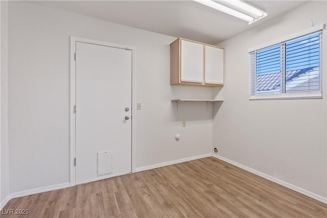 9105 Marble Dr, Las Vegas, NV 89134 - laundry area featuring cabinet space, light wood finished floors, and baseboards