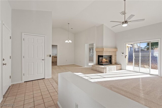 9105 Marble Dr, Las Vegas, NV 89134 - unfurnished living room with high vaulted ceiling, a fireplace, a ceiling fan, light tile patterned floors, and baseboards