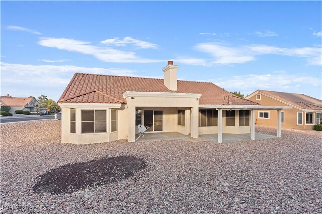 9105 Marble Dr, Las Vegas, NV 89134 - back of property with a tile roof, a patio, a sunroom, a chimney, and stucco siding