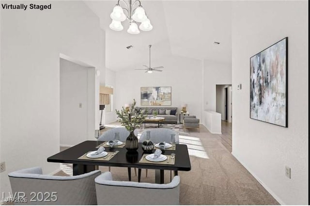 9105 Marble Dr, Las Vegas, NV 89134 - dining area with high vaulted ceiling, a chandelier, carpet, a ceiling fan, and baseboards