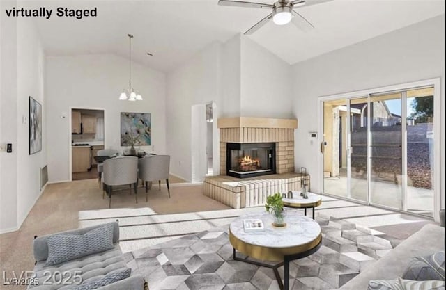 9105 Marble Dr, Las Vegas, NV 89134 - living room featuring a chandelier, high vaulted ceiling, light colored carpet, a ceiling fan, and a brick fireplace
