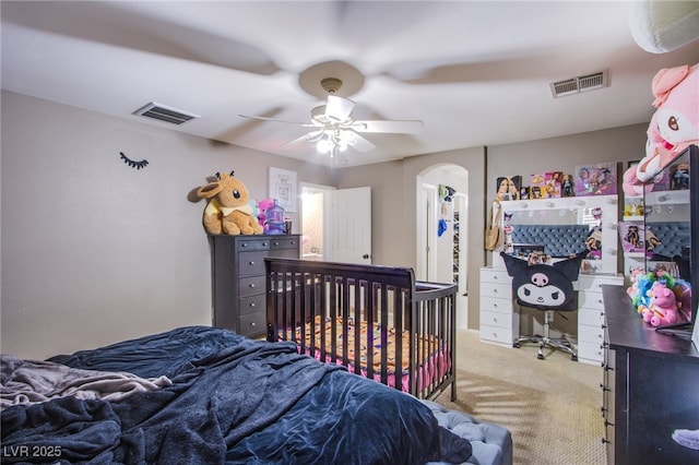 4429 E Azure Ave, Las Vegas, NV 89115 - bedroom with light colored carpet, arched walkways, and a ceiling fan