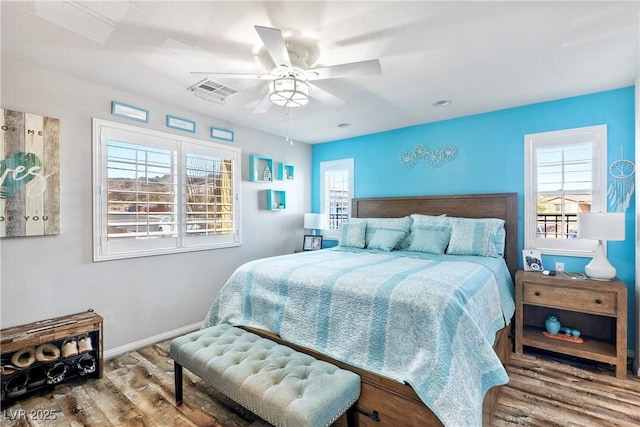 2225 Chandler Ranch Pl, Laughlin, NV 89029 - bedroom featuring wood finished floors, multiple windows, baseboards, and ceiling fan