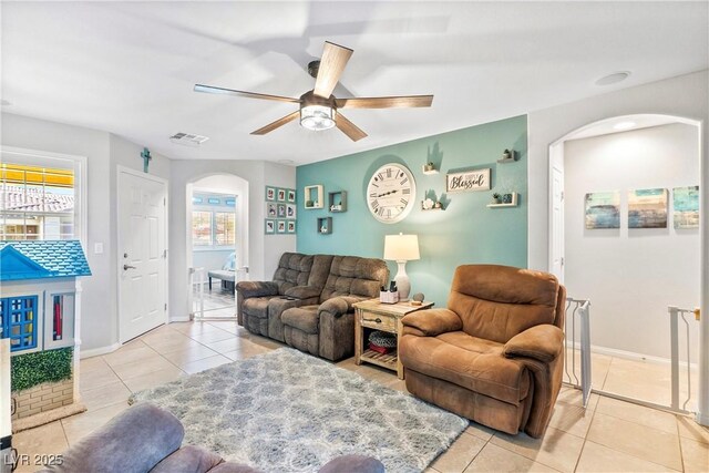 2225 Chandler Ranch Pl, Laughlin, NV 89029 - tiled living area featuring arched walkways, ceiling fan, and baseboards