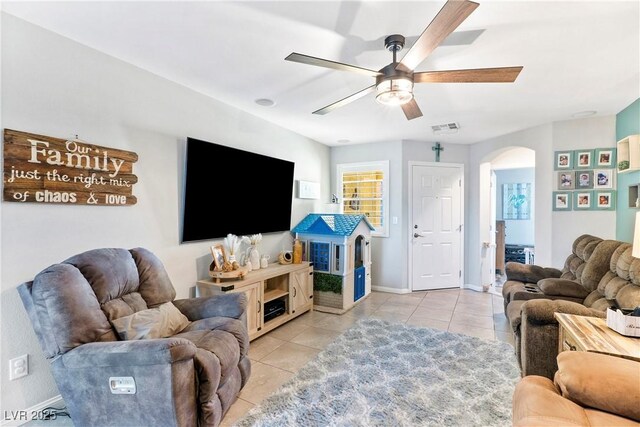 2225 Chandler Ranch Pl, Laughlin, NV 89029 - living room with arched walkways, a ceiling fan, light tile patterned floors, and baseboards
