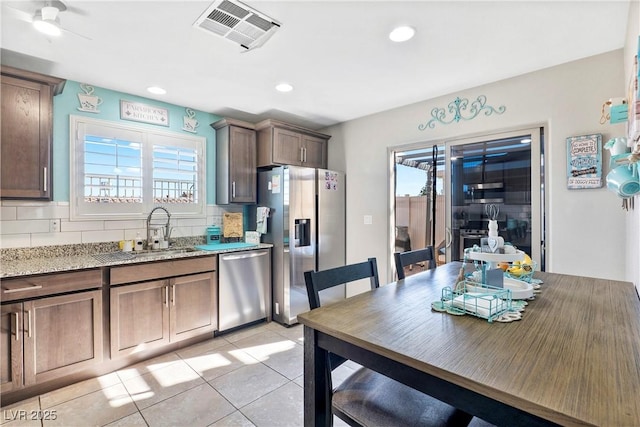 2225 Chandler Ranch Pl, Laughlin, NV 89029 - kitchen featuring stainless steel appliances, a sink, backsplash, light stone countertops, and recessed lighting