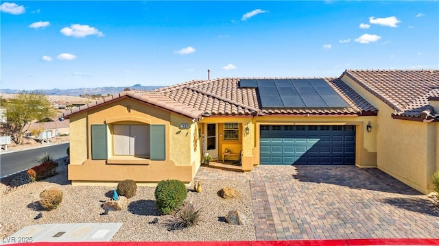 2225 Chandler Ranch Pl, Laughlin, NV 89029 - view of front of property featuring a garage, stucco siding, and solar panels