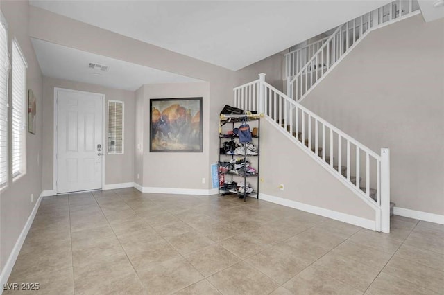 9840 Chief Sky St, Las Vegas, NV 89178 - entrance foyer featuring stairway, baseboards, and tile patterned floors