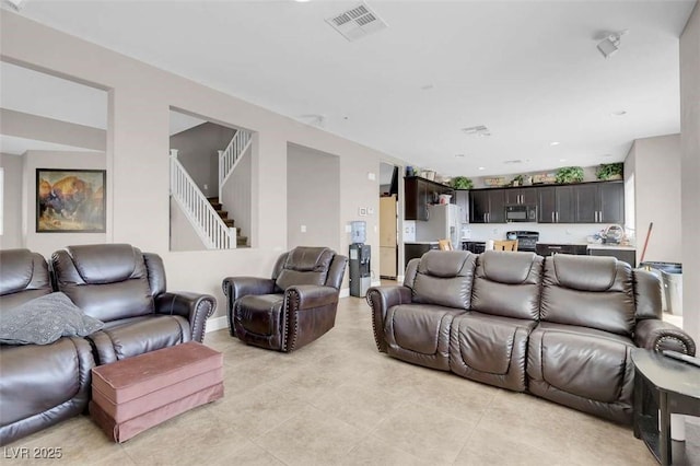 9840 Chief Sky St, Las Vegas, NV 89178 - living room featuring stairway and light tile patterned floors