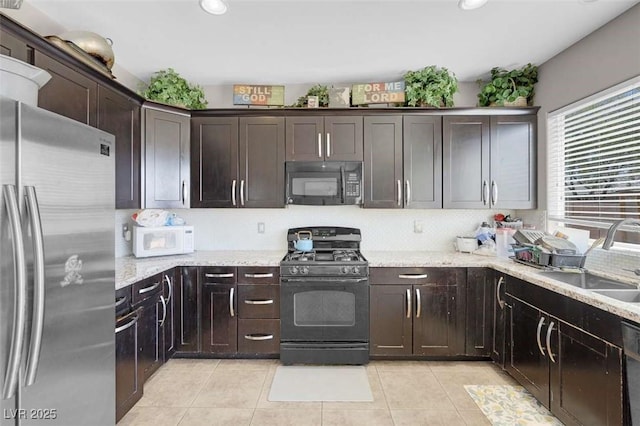9840 Chief Sky St, Las Vegas, NV 89178 - kitchen featuring black appliances, a sink, dark brown cabinets, light tile patterned flooring, and recessed lighting