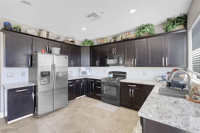 9840 Chief Sky St, Las Vegas, NV 89178 - kitchen featuring black appliances, a sink, light tile patterned floors, backsplash, and recessed lighting