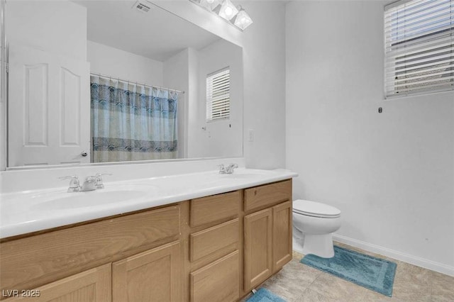 9840 Chief Sky St, Las Vegas, NV 89178 - full bathroom featuring toilet, double vanity, a shower with curtain, and plenty of natural light