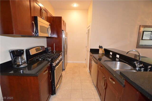 4585 Dean Martin Dr Unit 205, Las Vegas, NV 89103 - kitchen with appliances with stainless steel finishes, light tile patterned floors, a sink, recessed lighting, and baseboards