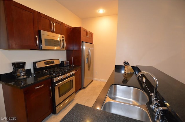 4585 Dean Martin Dr Unit 205, Las Vegas, NV 89103 - kitchen featuring appliances with stainless steel finishes, a sink, and dark countertops