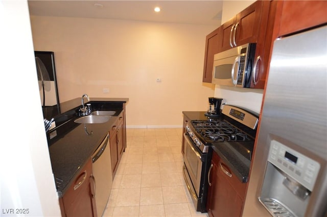 4585 Dean Martin Dr Unit 205, Las Vegas, NV 89103 - kitchen with stainless steel appliances, a sink, dark stone countertops, brown cabinets, and recessed lighting