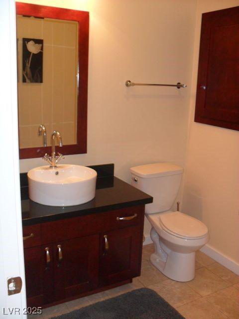 4585 Dean Martin Dr Unit 205, Las Vegas, NV 89103 - half bathroom with vanity, toilet, tile patterned flooring, and baseboards