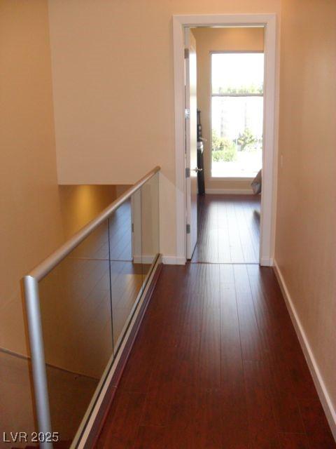 4585 Dean Martin Dr Unit 205, Las Vegas, NV 89103 - corridor featuring an upstairs landing, baseboards, and wood finished floors