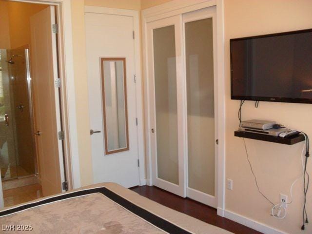 4585 Dean Martin Dr Unit 205, Las Vegas, NV 89103 - unfurnished bedroom with baseboards, wood finished floors, and a closet