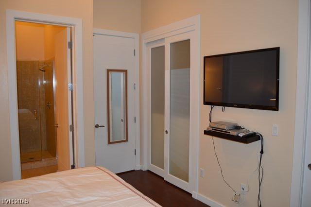 4585 Dean Martin Dr Unit 205, Las Vegas, NV 89103 - bedroom with baseboards and ensuite bath