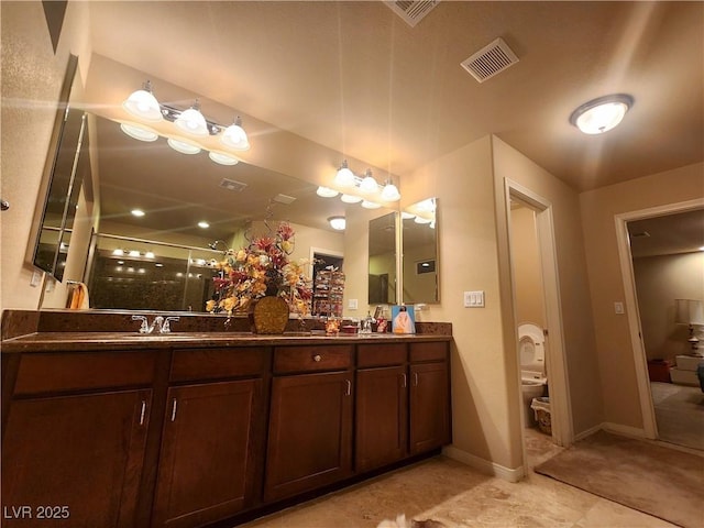 6729 Flamenco Ct, Las Vegas, NV 89139 - bathroom featuring double vanity, a stall shower, baseboards, and toilet