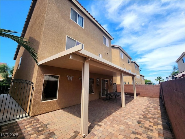 6729 Flamenco Ct, Las Vegas, NV 89139 - back of property with stucco siding, a fenced backyard, a gate, and a patio area