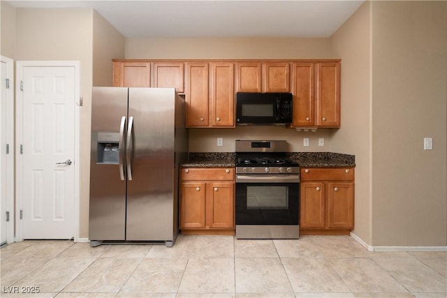 2708 Cheer Pheasant Ave, North Las Vegas, NV 89084 - kitchen with stainless steel appliances, dark stone countertops, and brown cabinets
